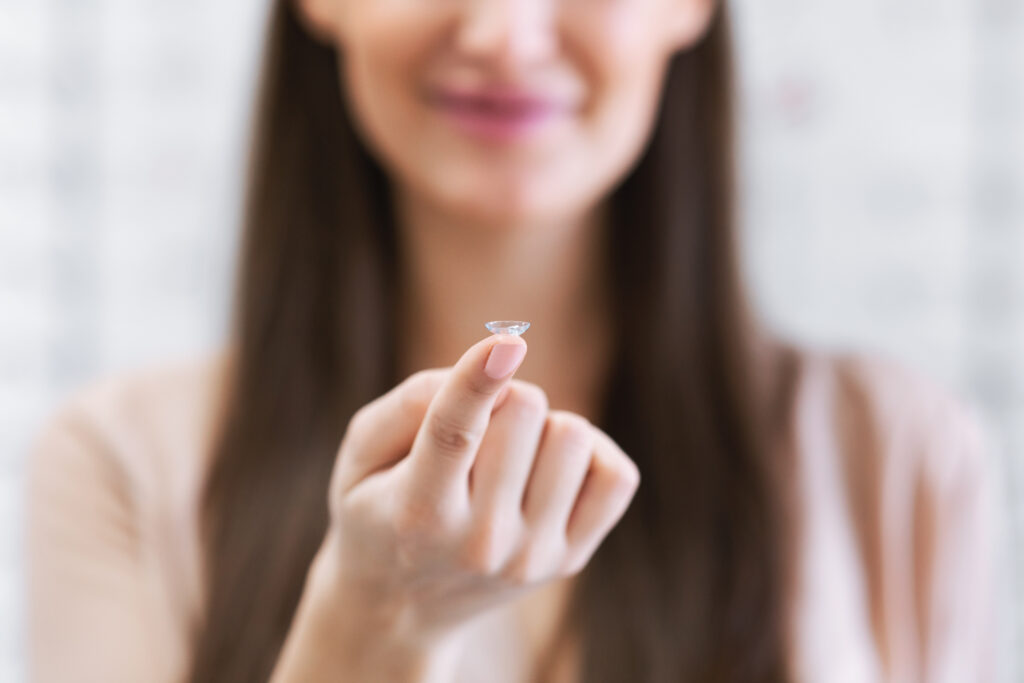 Lady holding contact eye lenses in optics store - McLean Eyecare Center
